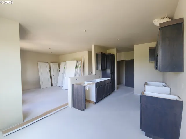 a large bedroom with a bed and a dresser in it