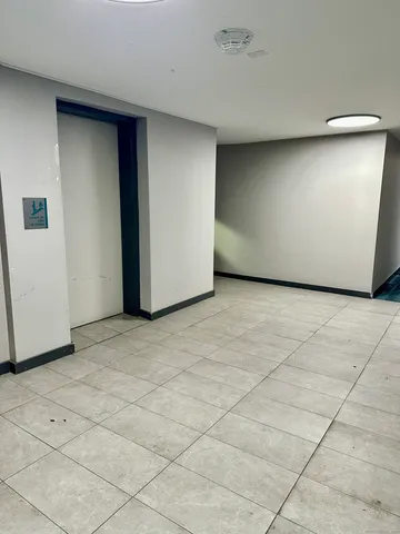 a view of a swimming pool with a bench and trees around