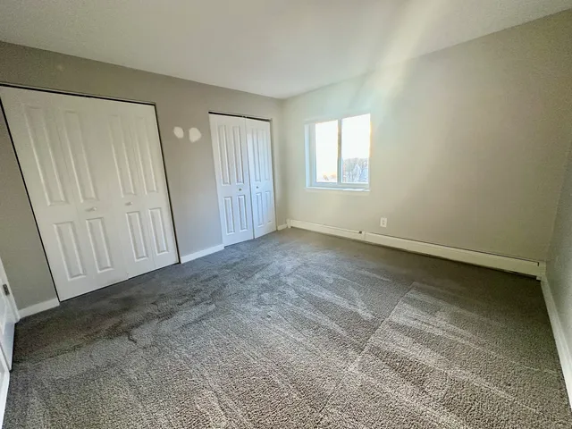 an empty room with a wooden door