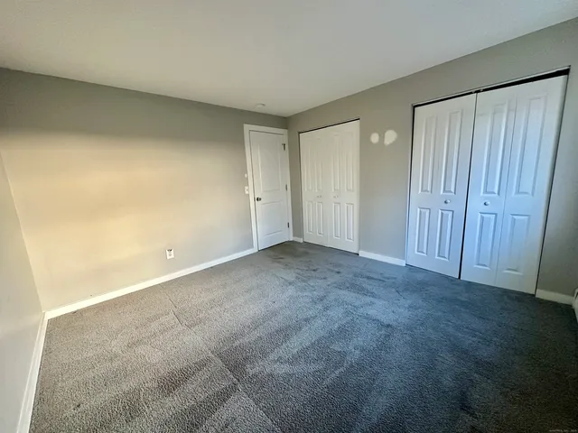 a view of an empty room and a window