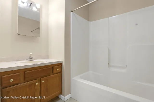 a bathroom with a sink a mirror and a bathtub