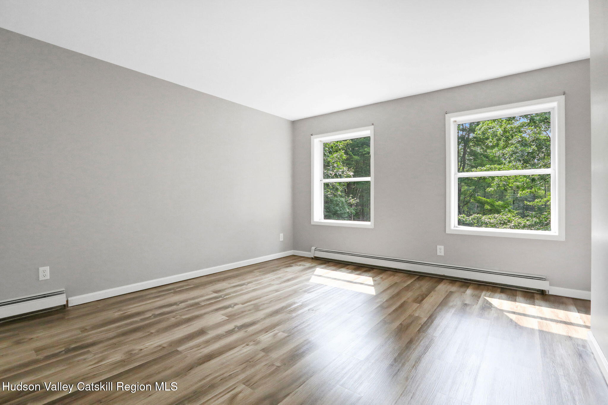 10 Lairds Court Purling, NY 12470 - Photo 18 of 25 an empty room with wooden floor and windows