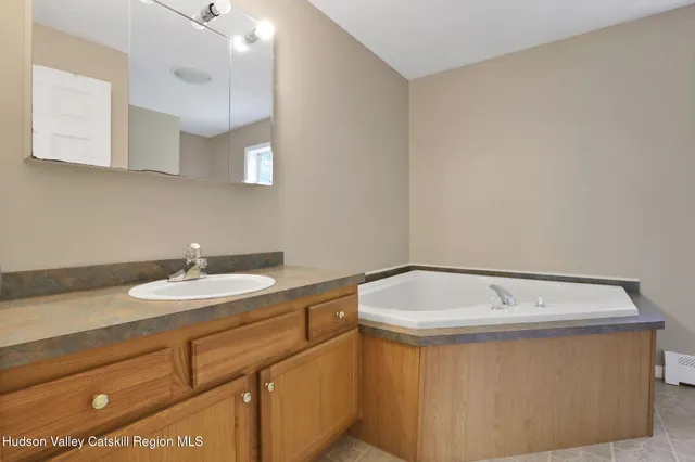 a bathroom with a sink a toilet and vanity