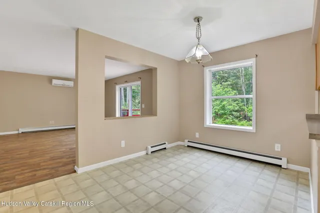 an empty room with windows and ceiling fan