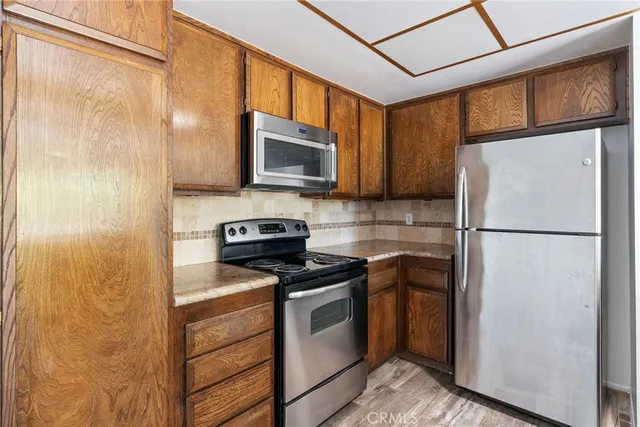 a kitchen with a refrigerator stove and microwave