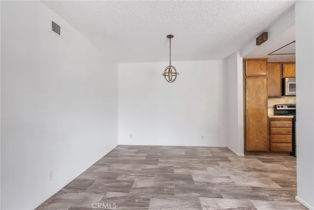 a view of a room with a closet and wooden floor