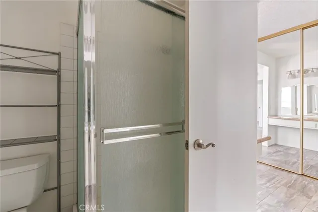 a bathroom with a glass shower door