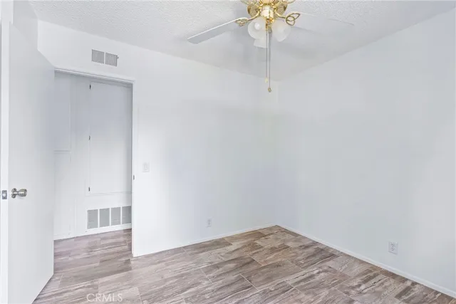 a view of an empty room with a fan