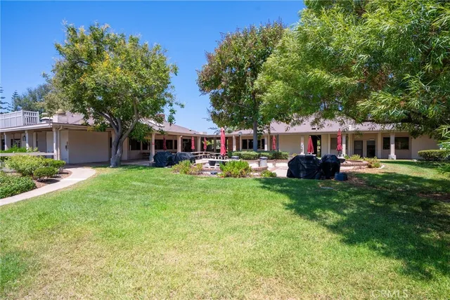 a front view of a house with a big yard