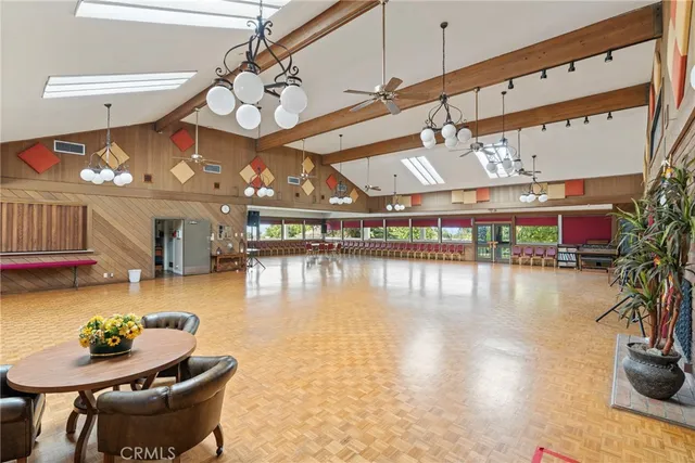 a dining room with furniture and a floor to ceiling window