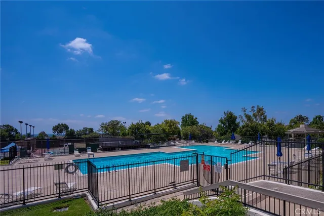 a view of a balcony with wooden floor and fence