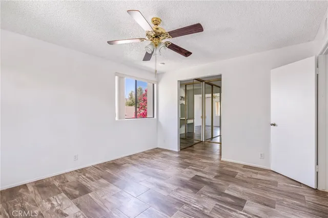 a view of an empty room with a ceiling fan