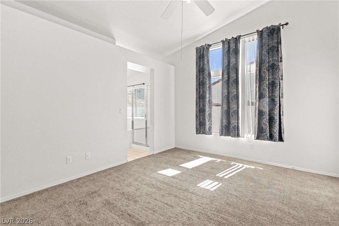 1815 Stablegate Avenue Henderson, NV 89012 - Photo 17 of 28 A private retreat featuring a vaulted ceiling and an attached bath for ultimate convenience.