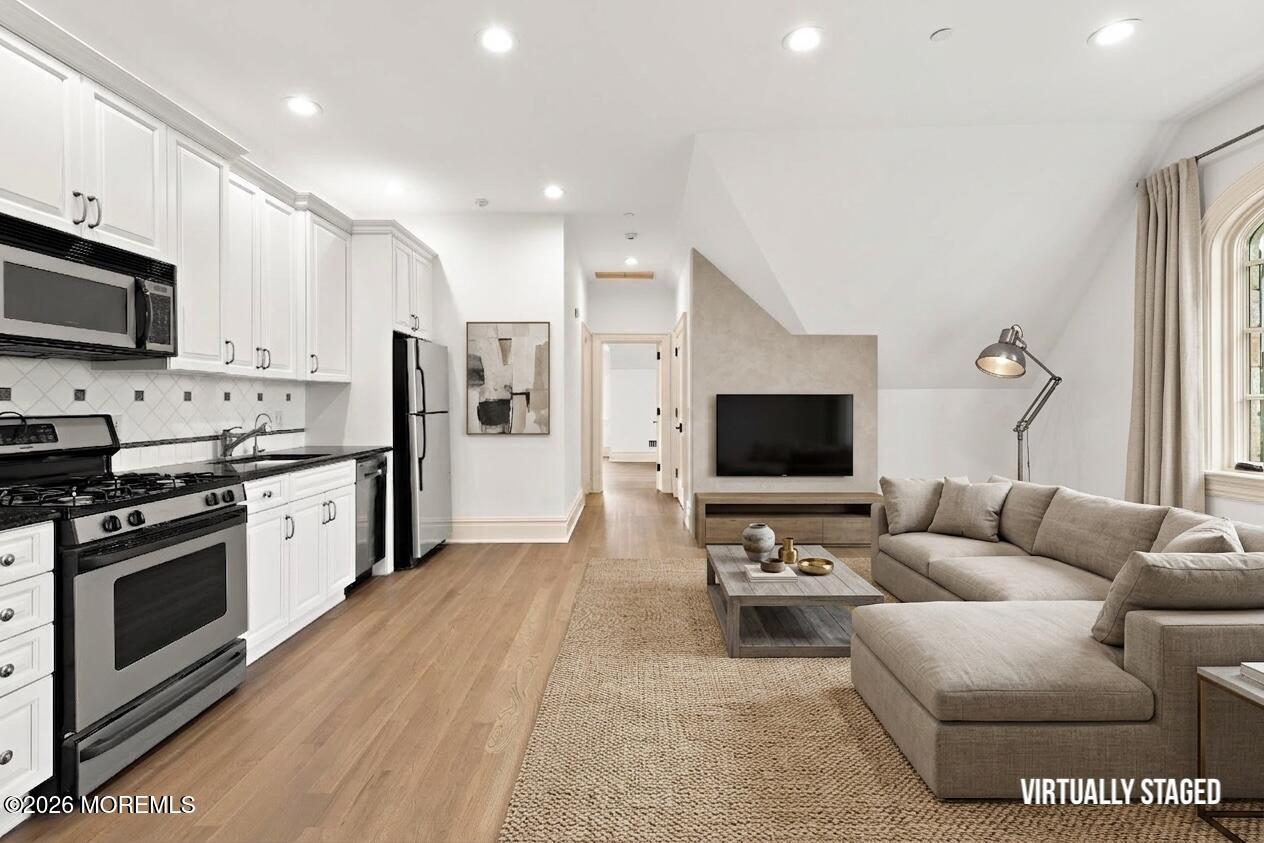88 Montrose Road Colts Neck, NJ 07722 - Photo 45 of 73 a living room with stainless steel appliances furniture and a flat screen tv
