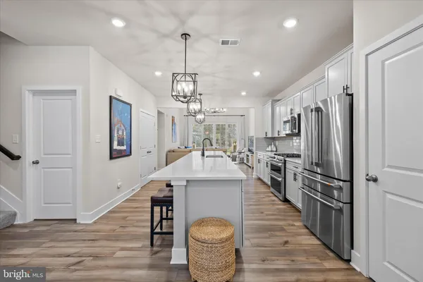 a large kitchen with stainless steel appliances kitchen island a large island in the center