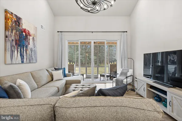a living room with furniture and a chandelier