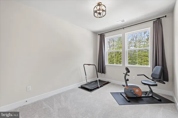 a spacious bathroom with a granite countertop sink mirror and toilet