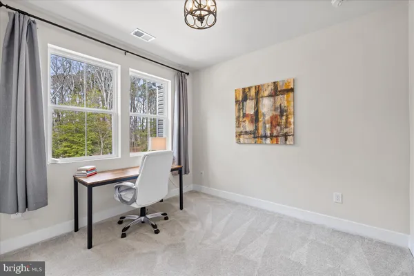 a bedroom with a bed and a lamp on table
