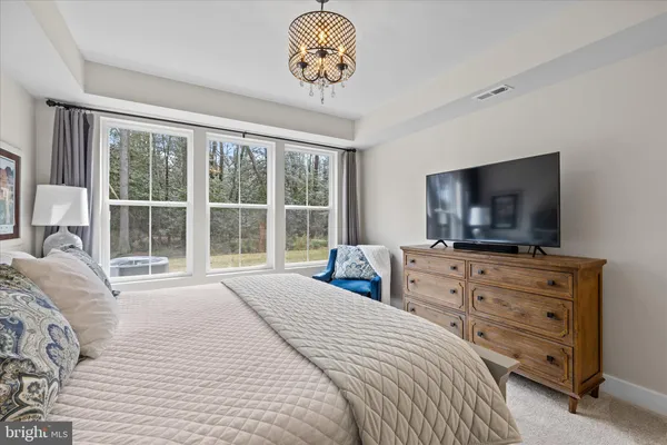 front view of a house with a yard and sitting area