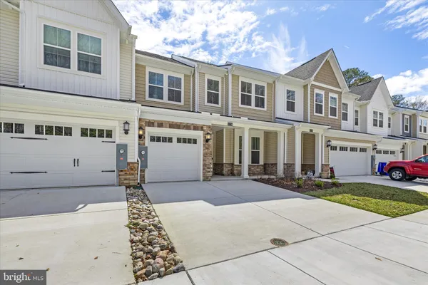 a view of a house with table and chairs in a patio