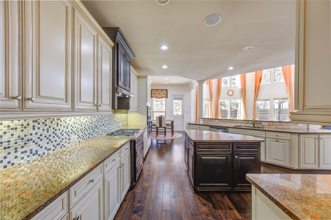 3806 Sims Pointe Court Fulshear, TX 77441 - Photo 12 of 50 a kitchen with stainless steel appliances granite countertop sink stove top oven and cabinets