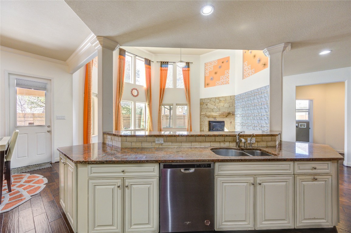 3806 Sims Pointe Court Fulshear, TX 77441 - Photo 16 of 50 a kitchen with granite countertop white cabinets and a granite counter tops