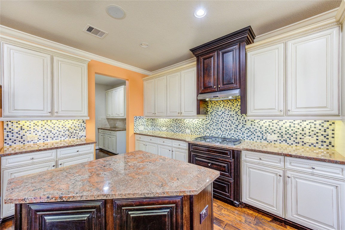 3806 Sims Pointe Court Fulshear, TX 77441 - Photo 17 of 50 a kitchen with granite countertop a sink stove and cabinets