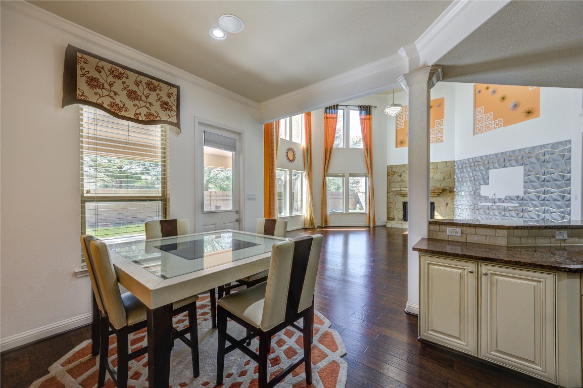 3806 Sims Pointe Court Fulshear, TX 77441 - Photo 18 of 50 a view of a a dining room with furniture window and wooden floor