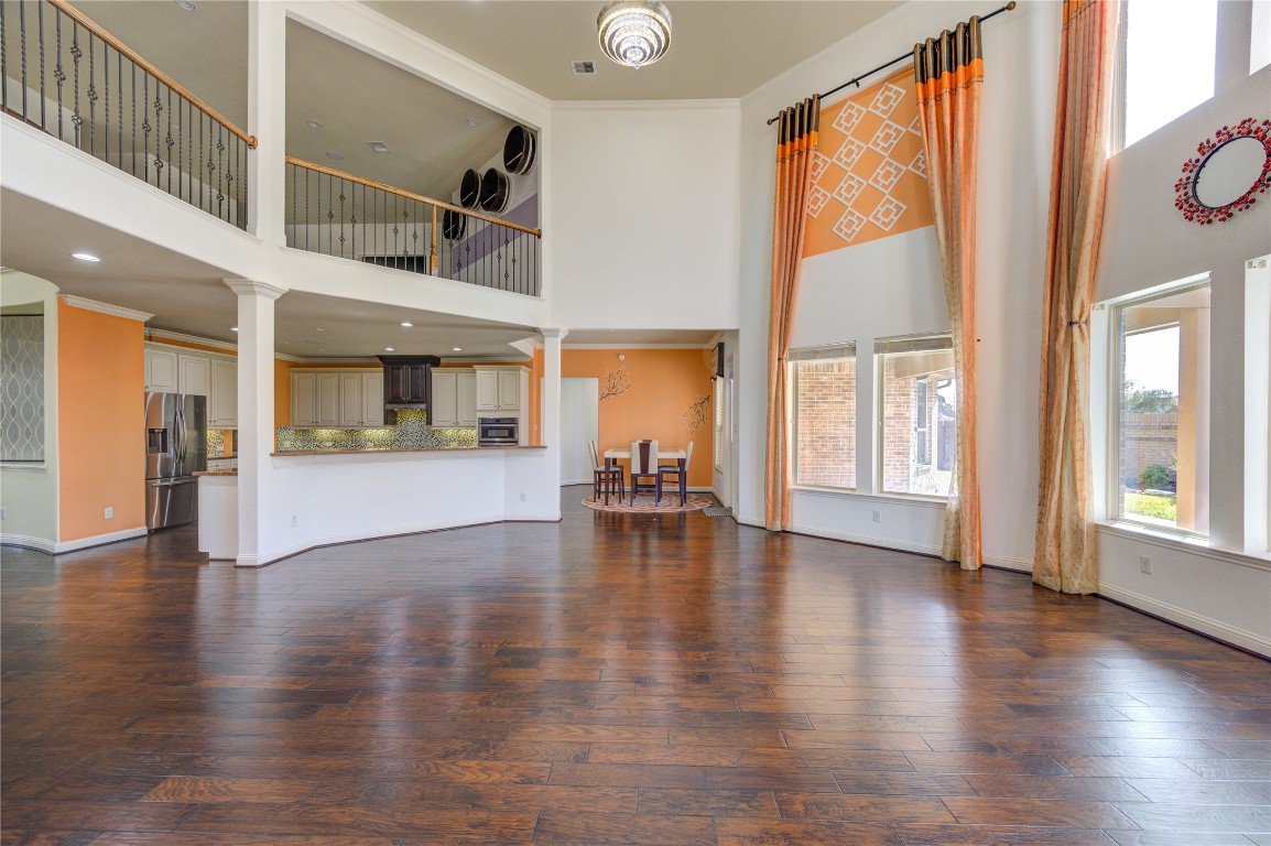3806 Sims Pointe Court Fulshear, TX 77441 - Photo 23 of 50 an empty room with wooden floor and windows