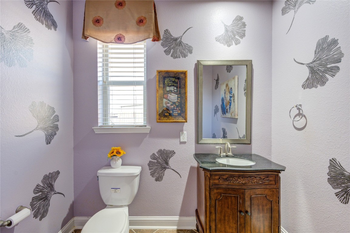 3806 Sims Pointe Court Fulshear, TX 77441 - Photo 25 of 50 a bathroom with a granite countertop toilet sink and mirror