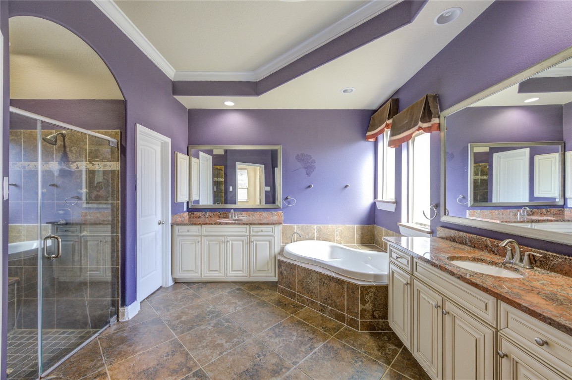 3806 Sims Pointe Court Fulshear, TX 77441 - Photo 28 of 50 a bathroom with a granite countertop sink mirror and a bathtub
