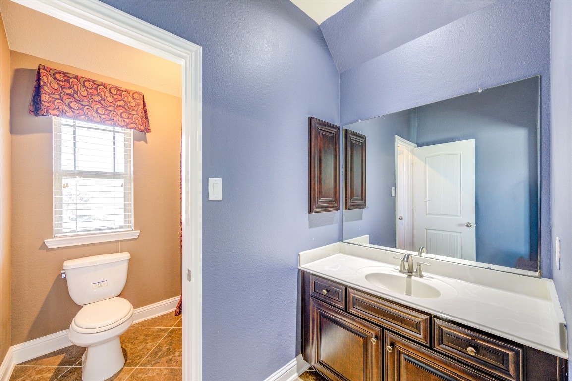 3806 Sims Pointe Court Fulshear, TX 77441 - Photo 37 of 50 a bathroom with a granite countertop sink toilet and mirror
