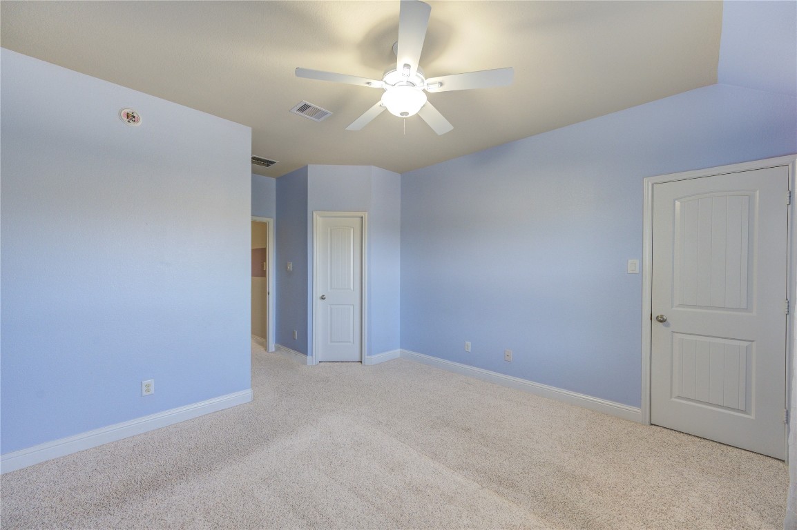 3806 Sims Pointe Court Fulshear, TX 77441 - Photo 38 of 50 a view of an empty room with a ceiling fan