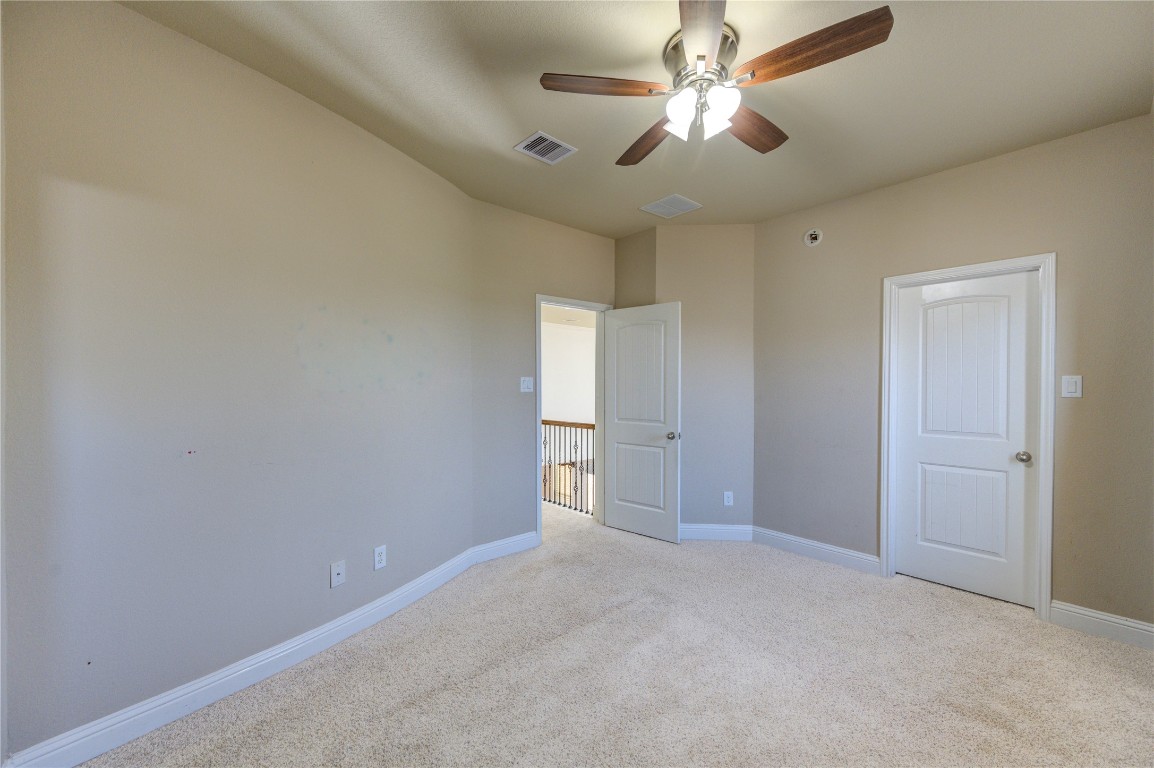 3806 Sims Pointe Court Fulshear, TX 77441 - Photo 40 of 50 en empty room with windows and fan