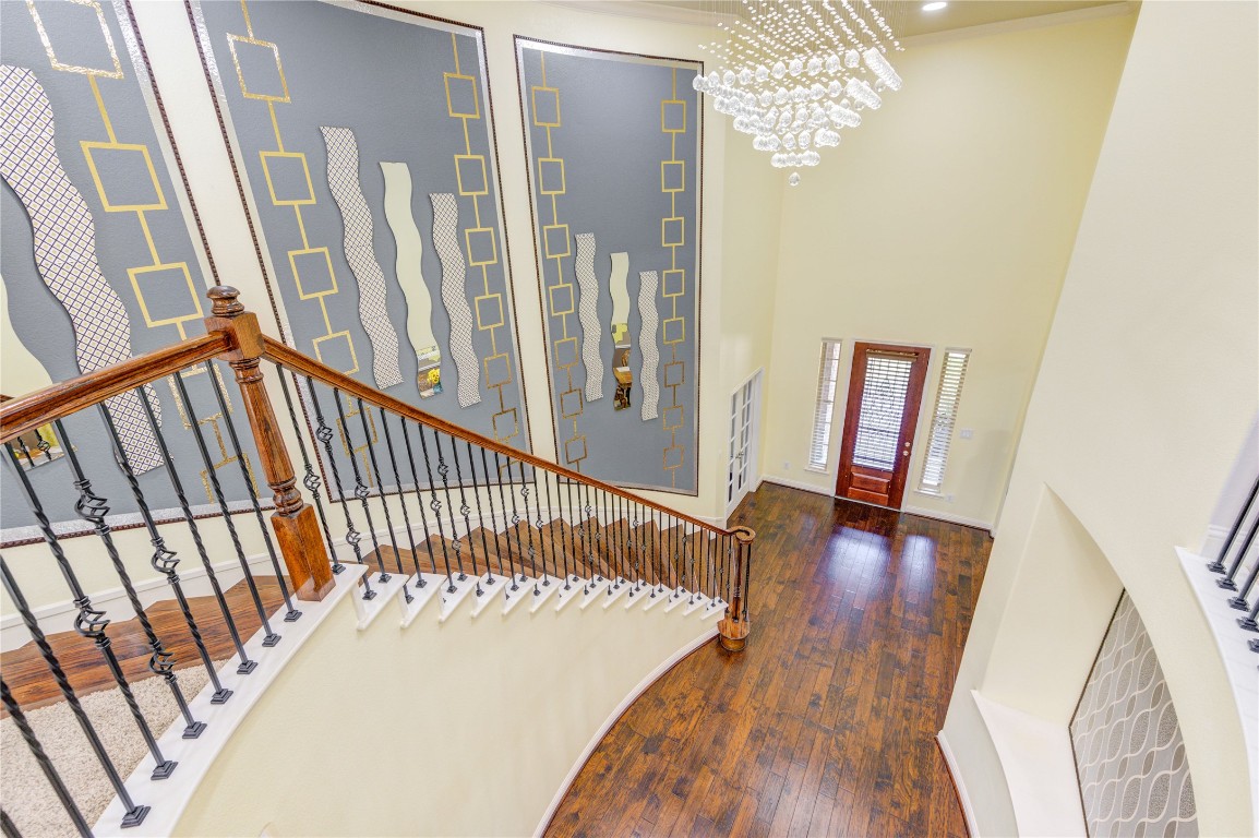 3806 Sims Pointe Court Fulshear, TX 77441 - Photo 43 of 50 a view of a hallway with wooden floor and stairs