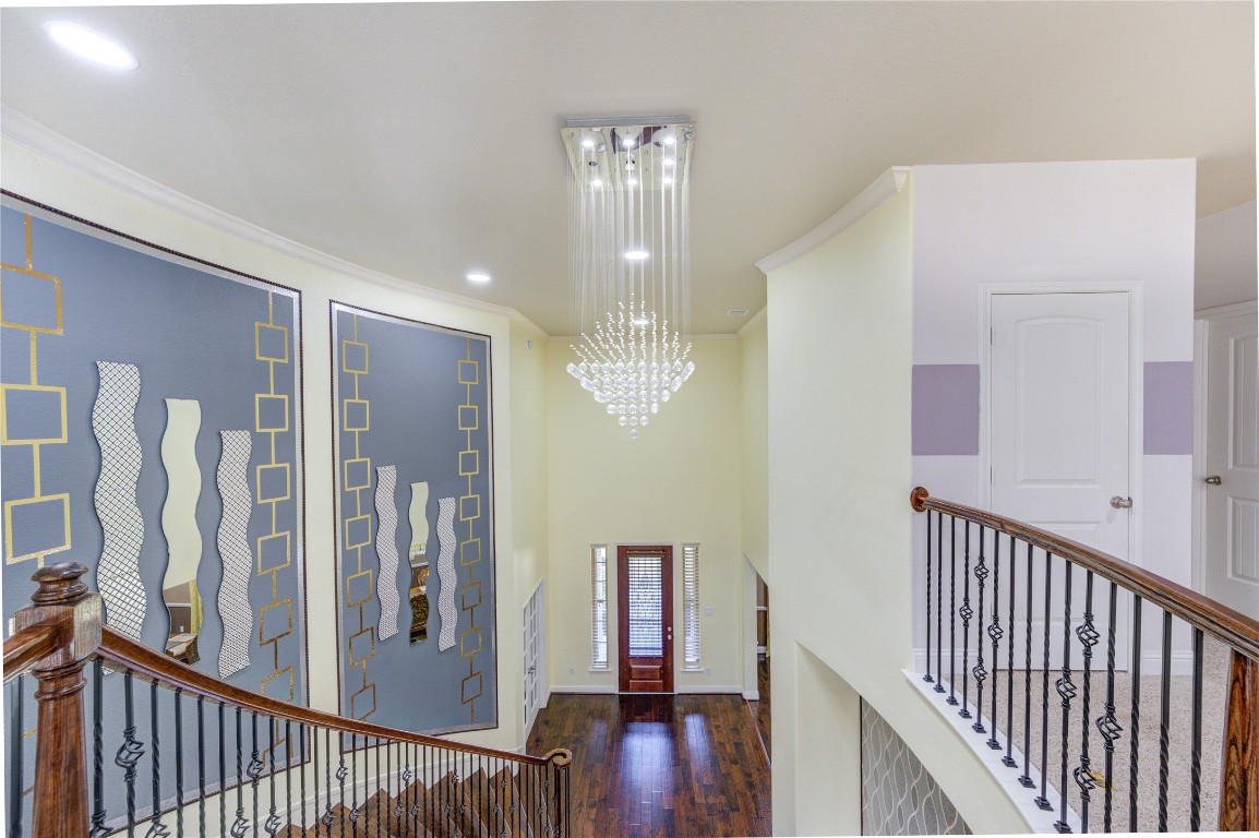 3806 Sims Pointe Court Fulshear, TX 77441 - Photo 45 of 50 a view of a hallway with wooden floor and staircase