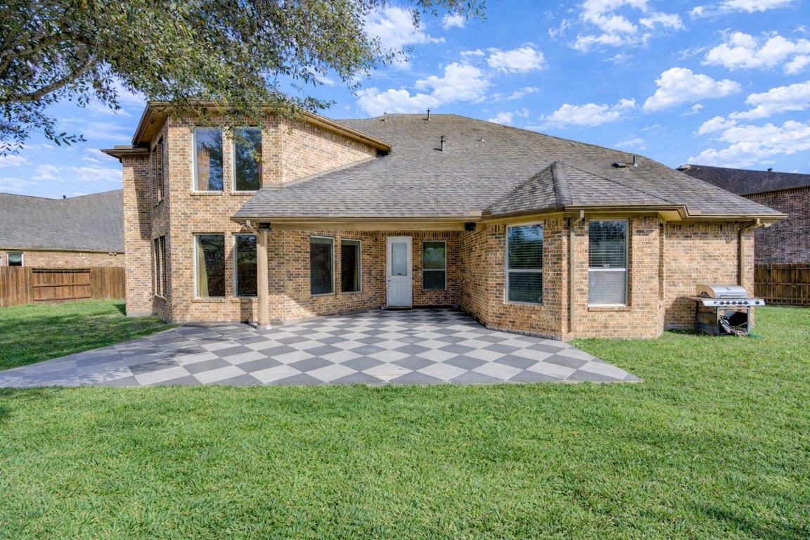 3806 Sims Pointe Court Fulshear, TX 77441 - Photo 47 of 50 a view of a yard in front of a house with large windows