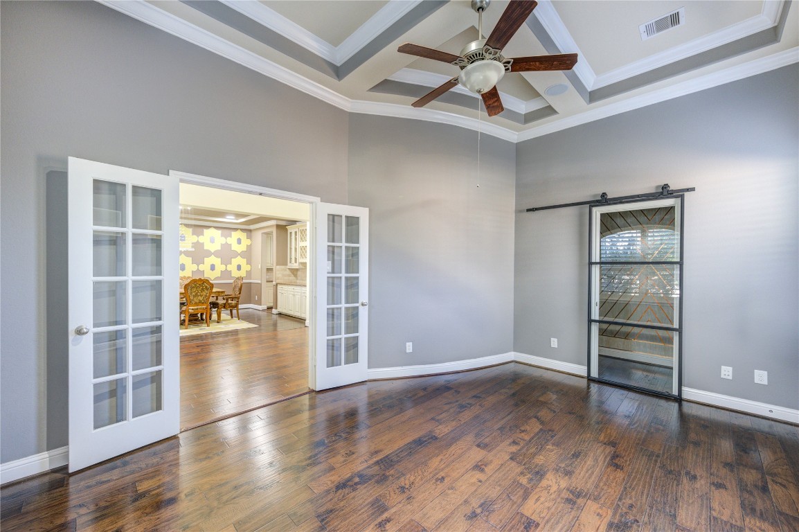 3806 Sims Pointe Court Fulshear, TX 77441 - Photo 8 of 50 an empty room with wooden floor and windows
