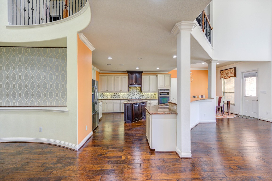 3806 Sims Pointe Court Fulshear, TX 77441 - Photo 10 of 50 a kitchen with a refrigerator and a wooden floor