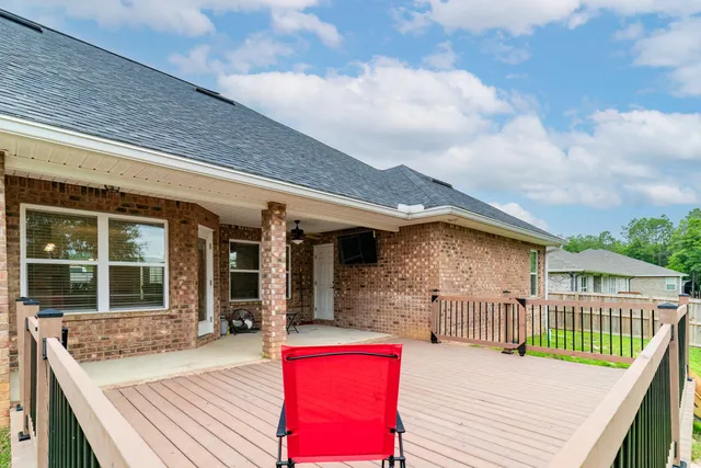 a view of a house with a yard and potted plants