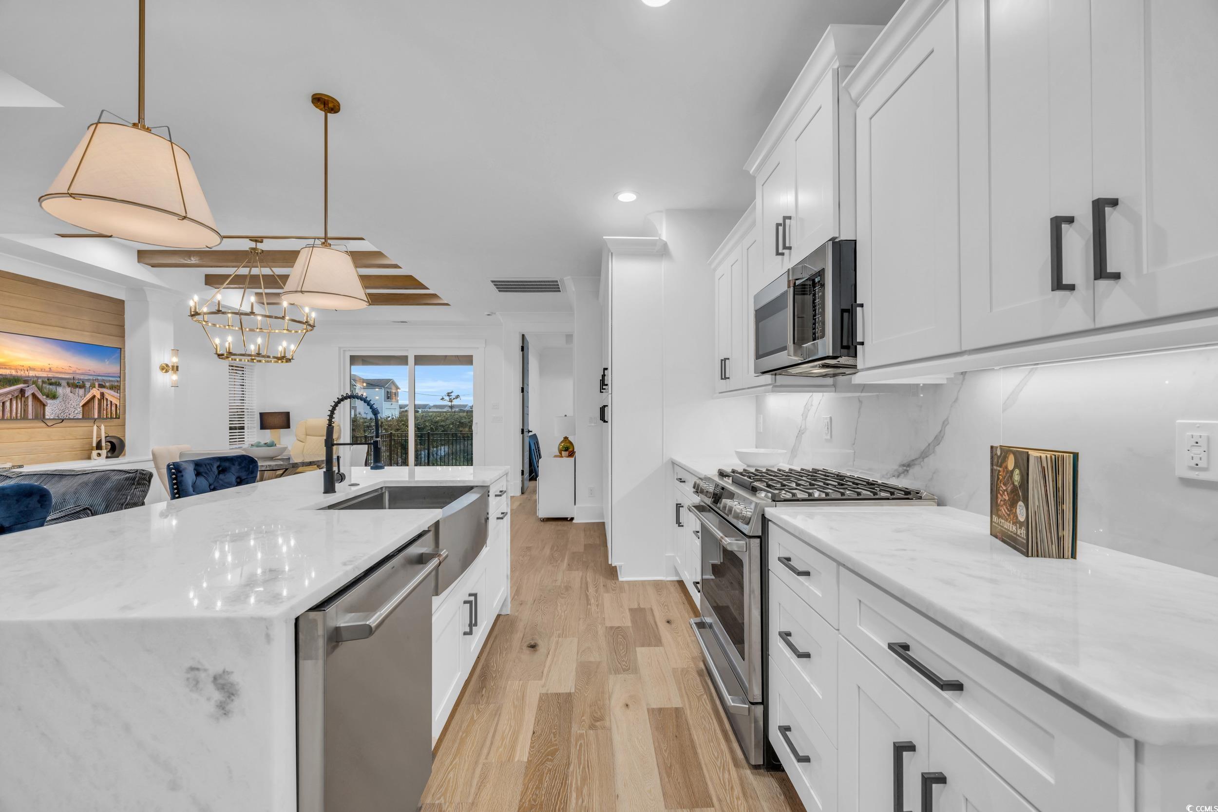 6703 Ocean Breeze Loop Myrtle Beach, SC 29572 - Photo 20 of 40 Kitchen featuring decorative backsplash, appliance