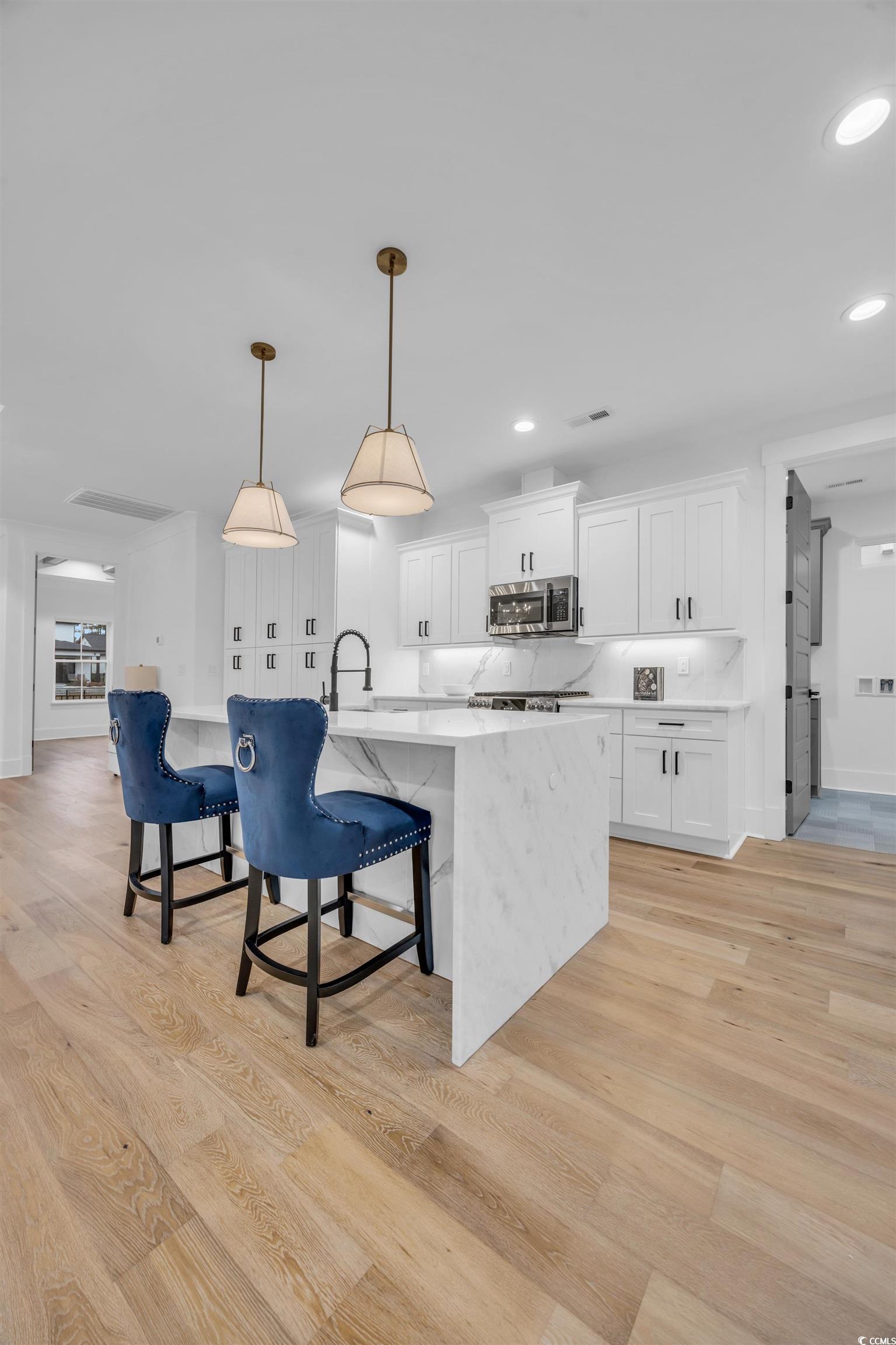 6703 Ocean Breeze Loop Myrtle Beach, SC 29572 - Photo 24 of 40 Kitchen with white cabinetry, tasteful backsplash,