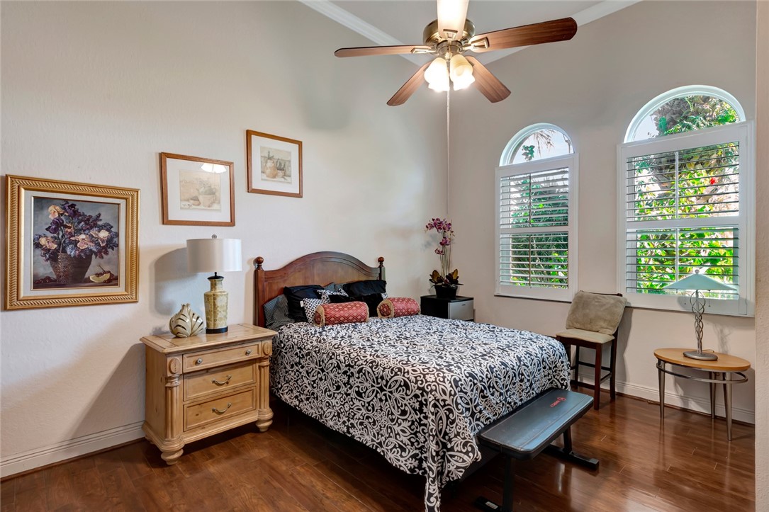 1781 Belmont Circle Southwest Vero Beach, FL 32968 - Photo 17 of 34 a bedroom with a bed and a chandelier