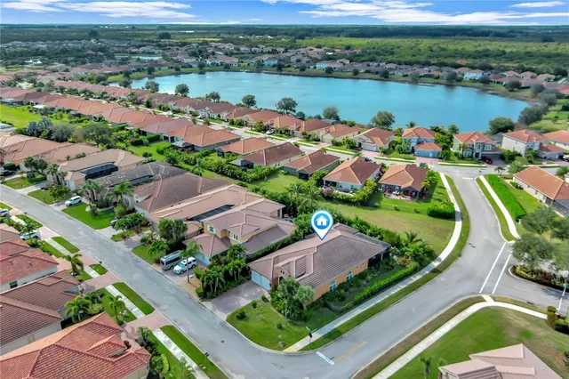 an aerial view of city lake and houses with outdoor space