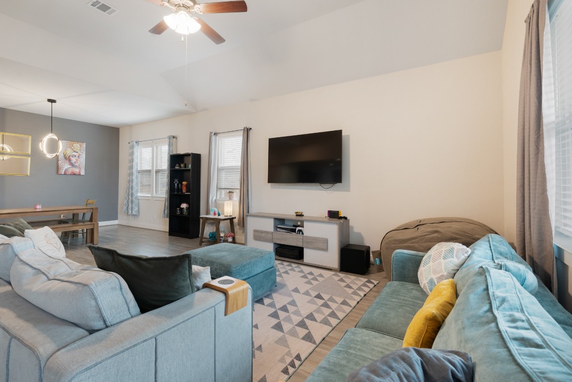 216 Emerald Garden Road San Marcos, TX 78666 - Photo 11 of 38 Living room featuring a ceiling fan, lofted ceiling, and wood finished floors