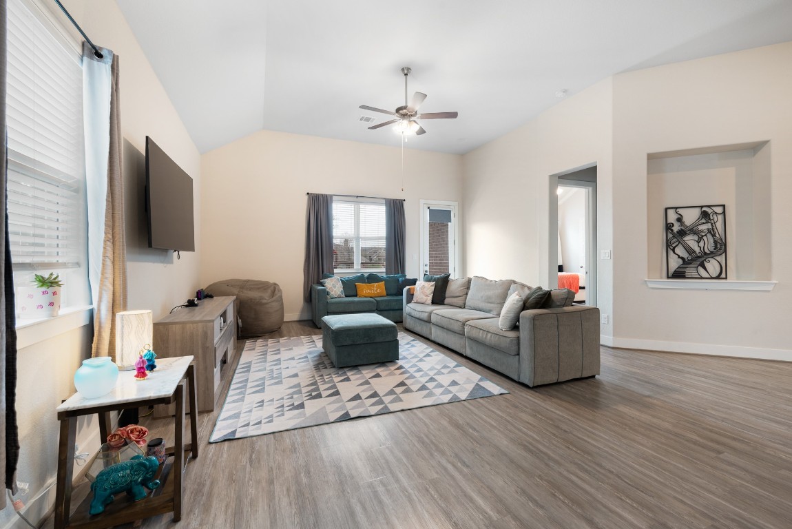 216 Emerald Garden Road San Marcos, TX 78666 - Photo 12 of 38 Living area featuring light wood-style floors, vaulted ceiling, and ceiling fan