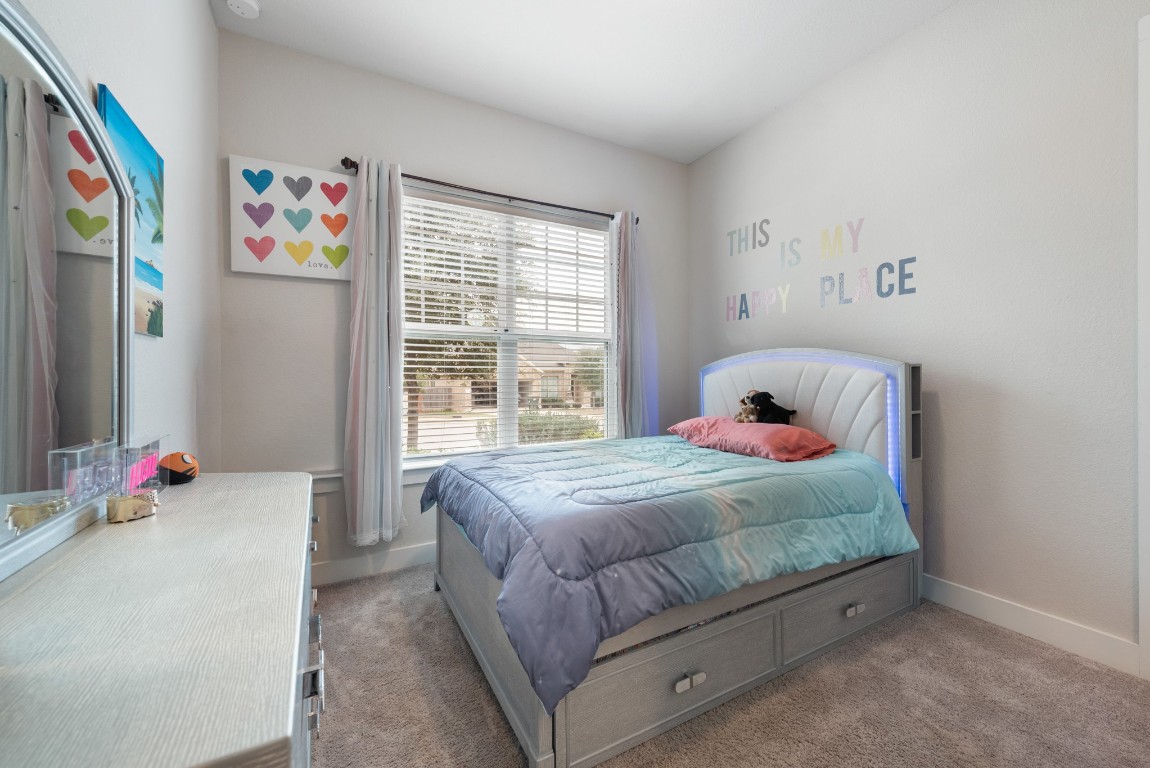 216 Emerald Garden Road San Marcos, TX 78666 - Photo 23 of 38 Carpeted bedroom featuring baseboards