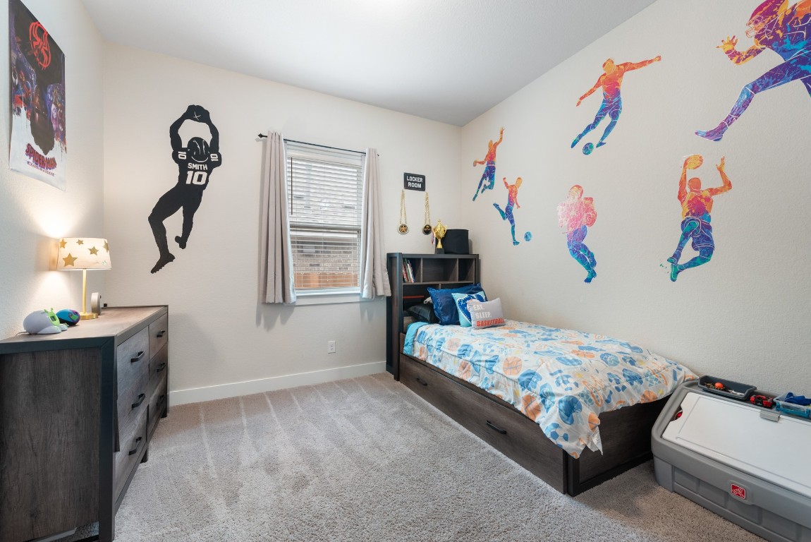 216 Emerald Garden Road San Marcos, TX 78666 - Photo 25 of 38 Bedroom featuring light colored carpet and baseboards