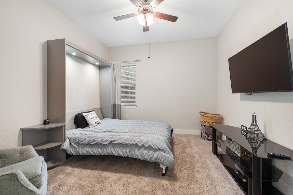 216 Emerald Garden Road San Marcos, TX 78666 - Photo 26 of 38 Bedroom with light colored carpet and a ceiling fan