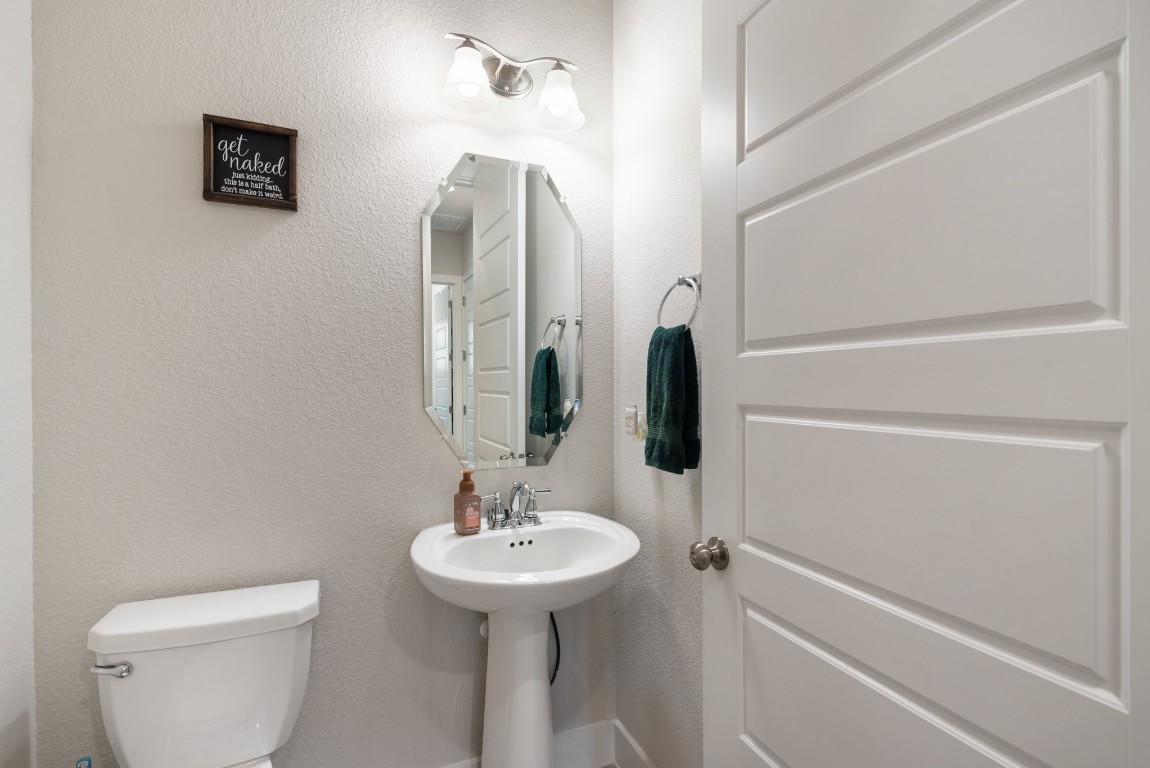 216 Emerald Garden Road San Marcos, TX 78666 - Photo 30 of 38 Bathroom with toilet and a textured wall